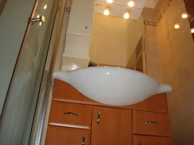 a bathroom with a white sink and a mirror at EASY JOURNEY Apartments in Prague