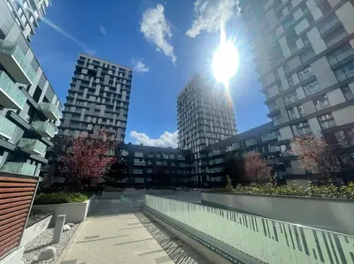 a city with tall buildings and the sun in the sky at Garden Park Studio in Prague