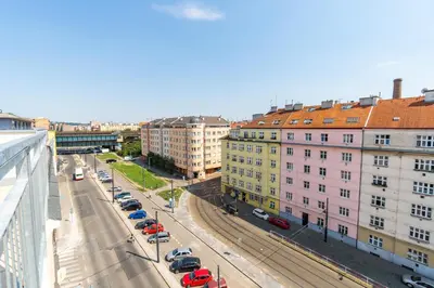 a view of a city street with parked cars and buildings at Brand new studio apartment # 42 in brand new building with free parking in the center in Prague