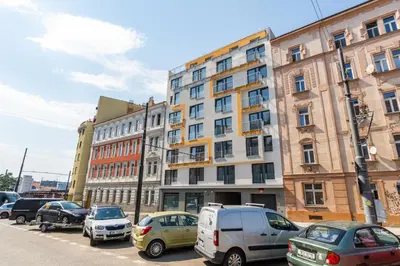 a parking lot with cars parked in front of a building at Studio brand new apartment #28 in new building with free parking in city center in Prague