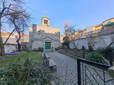 an old building with a green door and benches at Apartment in Zizkov -301- in Prague