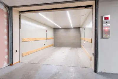an empty room with a garage door in a building at Brand new two room apartment #34 with free secure parking in the center in Prague