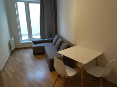 a living room with a couch and a table at Brand new two room apartment #34 with free secure parking in the center in Prague