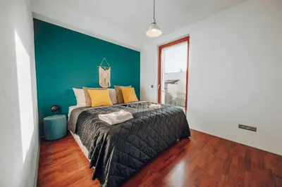 a bedroom with a bed with a blue accent wall at Design 3BD apartment cooking area in architect villa in Prague