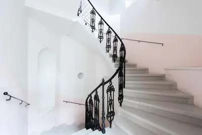 a white staircase with black railings in a house at 2 bedrooms apt near Wenceslas sq in Prague