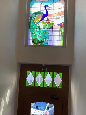 a stained glass window above the door of a church at 2 Bed Flat - Sleeps 9 - Pets - Smoking on terrace in Prague