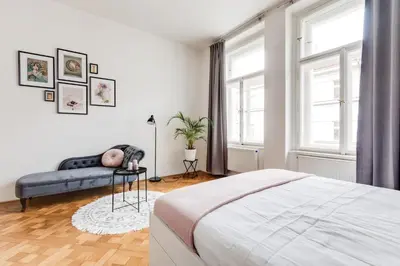 a white bedroom with a bed and a couch at Modern & Stylish Prague Apartments, Multiple Units in Prague