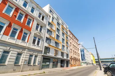 a row of buildings on a city street at Brand new one bedroom apartment #54 in brand new building with free parking in Prague