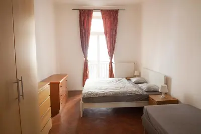 a bedroom with a bed and a window at 2B Pechackova family apartment with balcony by the river in Prague