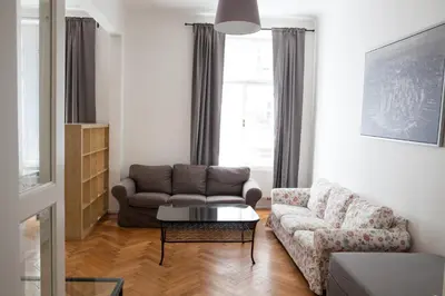 a living room with a couch and a coffee table at 2B Pechackova family apartment with balcony by the river in Prague