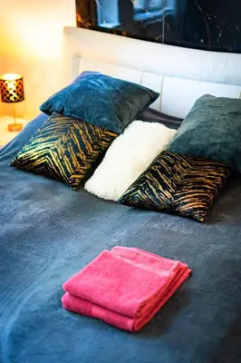 a bed with two pillows and a towel on it at Emperors Elegance Suite in Prague