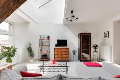 a living room with a couch and a table at Lenka's cozy Red studio + Lenka's cozy Gold apartment in Prague