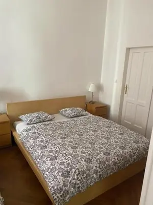 a bed with two pillows on it in a bedroom at Large 3 bedroom family apartment close to the river in Prague