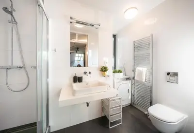 a white bathroom with a sink and a toilet at 5BR+2Bath Old Town Industrial Penthouse, A/C in Prague