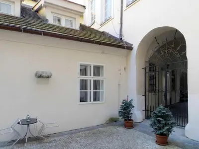 a white building with a gate and two potted plants at Apartment Old Town home-1 by Interhome in Prague