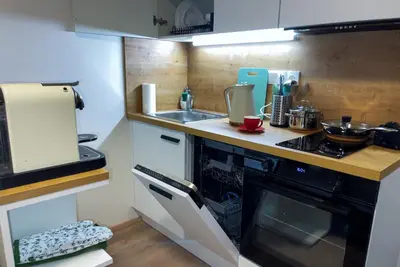 a small kitchen with a stove and a sink at Residence My Mozart in Prague