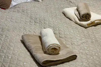 two towels are laying on a bed at Rezidence My Mozart in Prague