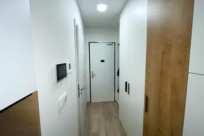 a hallway with two white doors and a television at Rezidence My Mozart in Prague