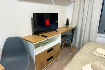 a room with a tv on a desk with a chair at Rezidence My Mozart in Prague