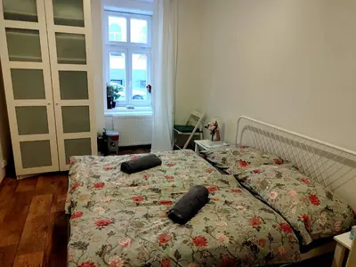 a bedroom with a bed with two pillows on it at Nice room with double bed in zizkov - shared bathroom in Prague