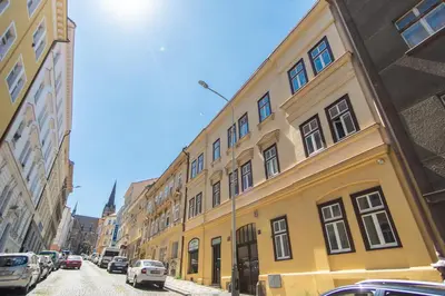 a yellow building on the side of a street at Nice room with double bed in zizkov - shared bathroom in Prague