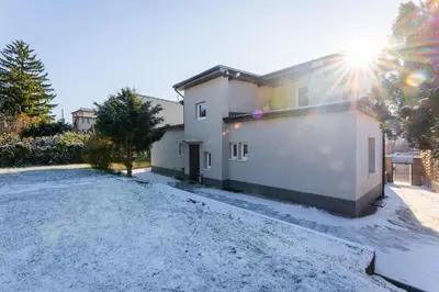 a house with a driveway in front of it at Apartmány Praha-Modřany in Prague