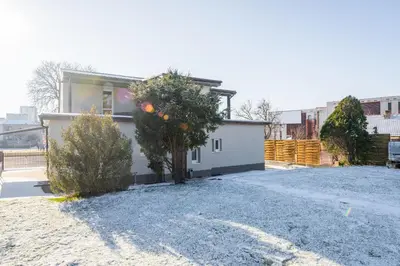 a house with a tree in the driveway at Apartmány Praha-Modřany in Prague