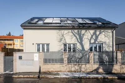 a house with solar panels on the roof at Apartmány Praha-Modřany in Prague