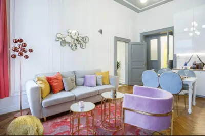 a living room with a couch and some chairs at Urban Premier Suite in Prague