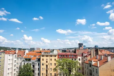 a view of a city with buildings and a blue sky at 1 bedroom apartment with terrace and FREE parking near metro in Prague