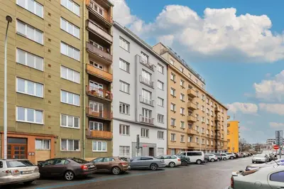 a row of buildings on a city street with cars parked at 2 rooms apartment with terrace and FREE parking near metro in Prague