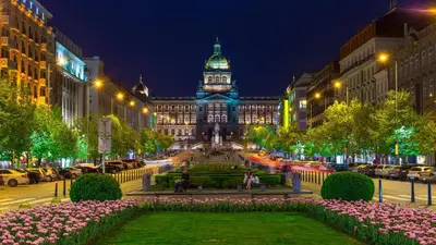 a large building with a clock tower at night at Brilliant Deluxe Suite in Prague