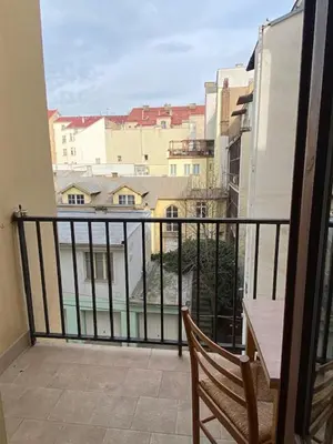 a balcony with a bench and a view of a city at 1 Bed Flat - Sleeps 2 - Pets - Smoking on terrace in Prague