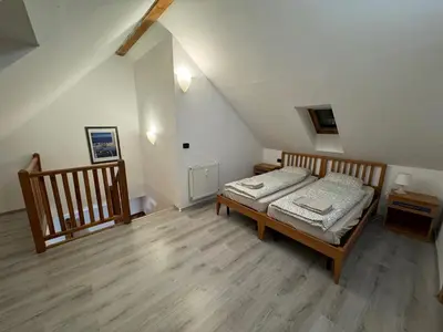 a bedroom with a bed and a wooden floor at 1 Bed Flat - Sleeps 4 - Pets - Smoking on terrace in Prague