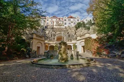 a house with a fountain in front of a building at Best location in Prague! 4 bedrooms and super host! in Prague