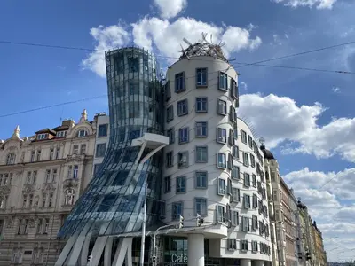 a tall white building with a glass building at Apartment Art Lounge by Interhome in Prague