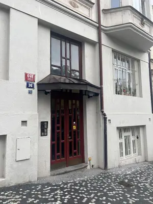 a building with a red door on a street at Modern Apartment in the Heart of Vršovice in Prague