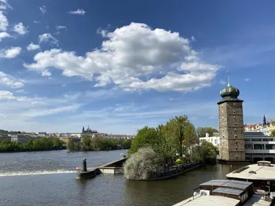 a view of a river with a tower in the water at Apartment Old Town home-3 by Interhome in Prague
