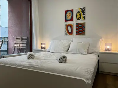 a white bed with towels on it in a bedroom at Apartment A l Modern Stay with Parking in Prague