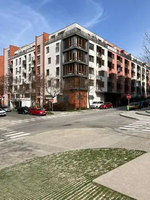 an empty street with a large apartment building at Apartment B l Modern Stay with Parking in Prague