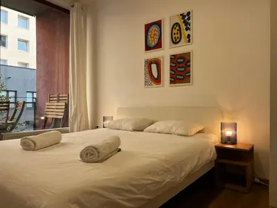 a bedroom with a bed with two pillows on it at Two Modern Apartments with Complimentary Parking in Prague