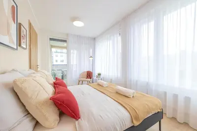 a bedroom with a large bed with red pillows at Bright 2BR - 4th floor, Balcony, Free Parking by Gravity Prague in Prague