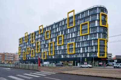 a large yellow building with a sign that reads hotel at NEW Apartment - O2 Arena Prague with parking in Prague