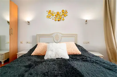 a bedroom with a bed with a black comforter at River Deluxe Suite in Prague