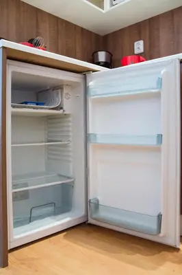an empty refrigerator with its door open in a kitchen at Modern Apartments Opatovická in Prague