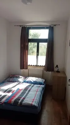 a bedroom with a bed in front of a window at Ubytování Ždírec - Apartmán 1 in Ždírec
