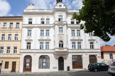 a large white building on a city street at Blueground Vršovice furnished equipped PRG-5 in Prague