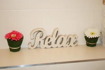 a sign for a room with three flower pots on a shelf at Apartment Sophia in Prague