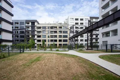 a large apartment building with a grassy yard in front of it at Blueground Holešovice family-friendly nr park PRG-3 in Prague