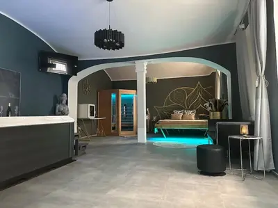 a large living room with a bed in the background at Offspa privátní wellness in Prague